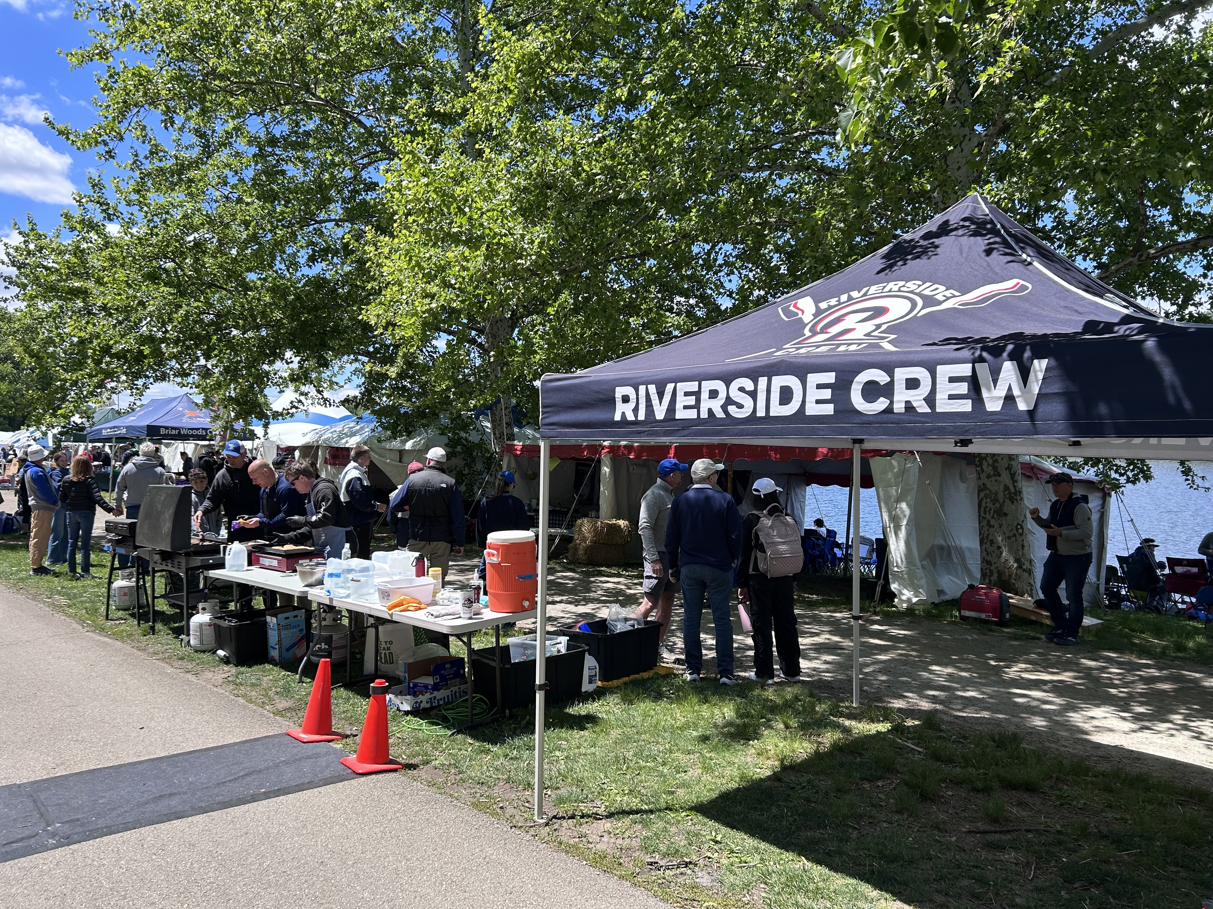 Riverside Crew hospitality tent with families and volunteers at a regatta
