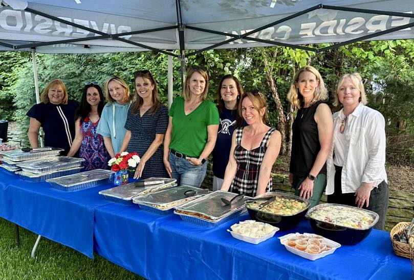 Riverside parent volunteers behind a prepared team meal