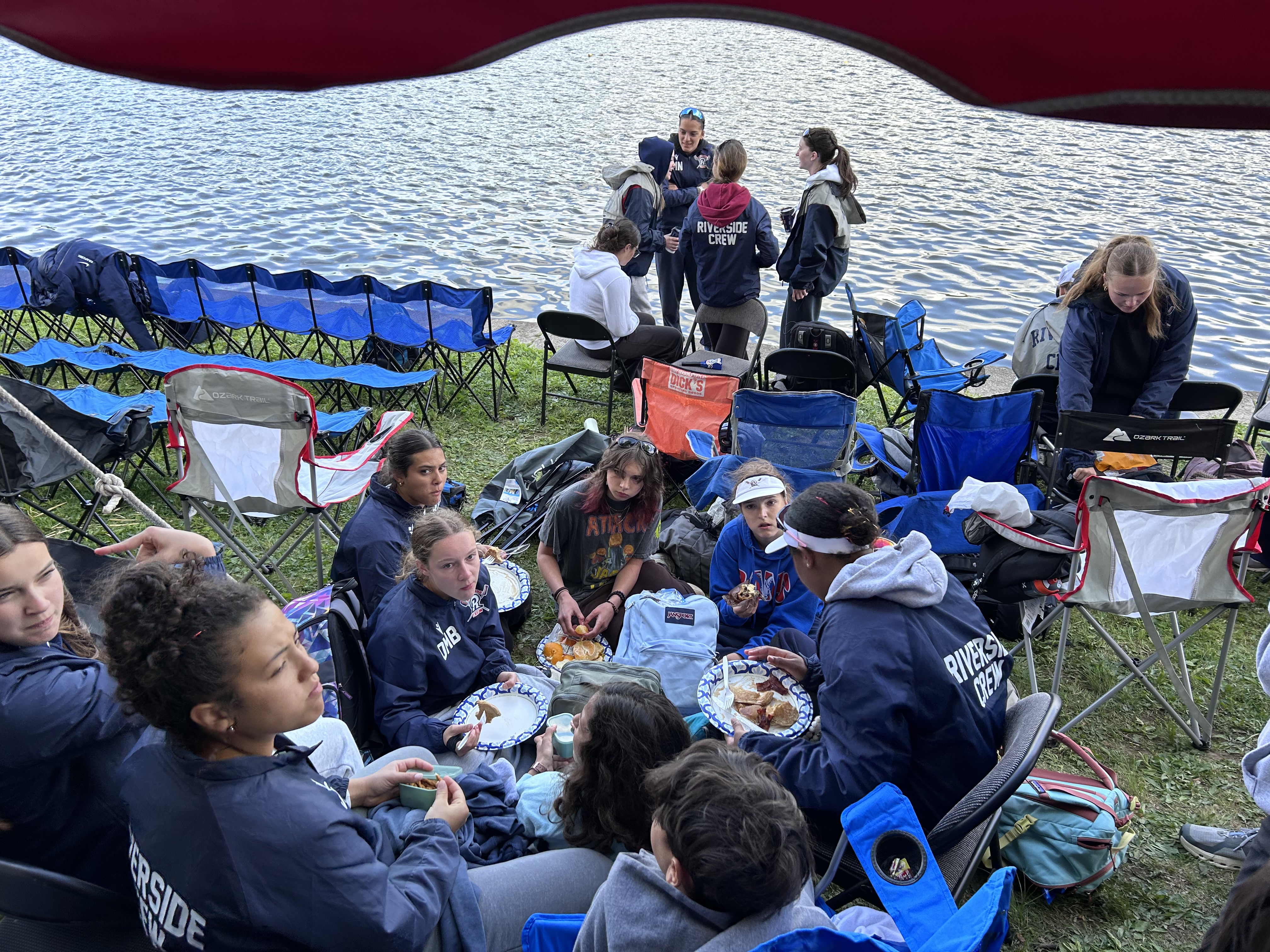Riverside athletes sharing a meal together at the riverside team tent